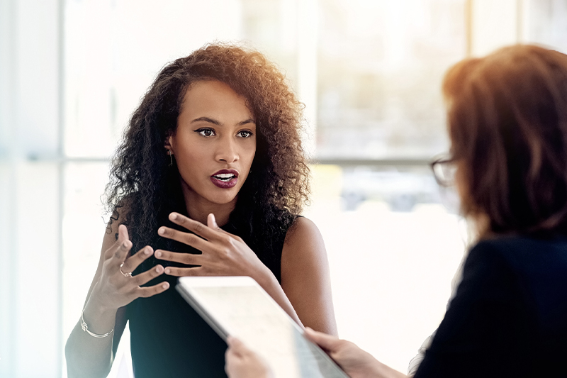 Two women talking with each other